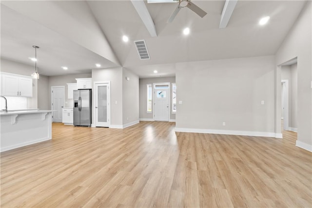 unfurnished living room with a ceiling fan, light wood finished floors, baseboards, recessed lighting, and high vaulted ceiling