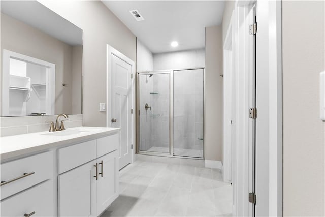 full bathroom featuring a shower stall, vanity, baseboards, and recessed lighting