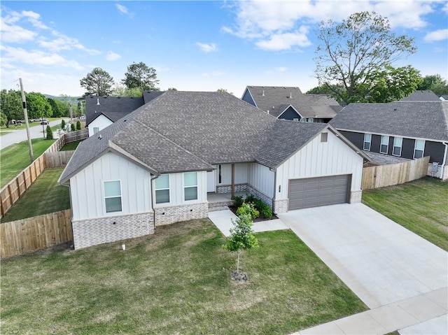 view of front facade with board and batten siding, an attached garage, roof with shingles, and concrete driveway