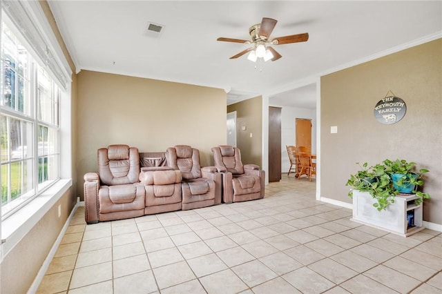 1014 Alma Ave, Mulberry, AR 72947 - living area featuring light tile patterned floors, ceiling fan, baseboards, and ornamental molding