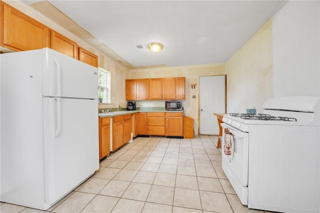 1014 Alma Ave, Mulberry, AR 72947 - kitchen with white appliances, a sink, light countertops, and light tile patterned floors