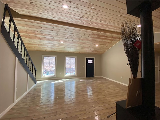 unfurnished living room featuring healthy amount of natural light, baseboards, wood ceiling, stairway, and recessed lighting