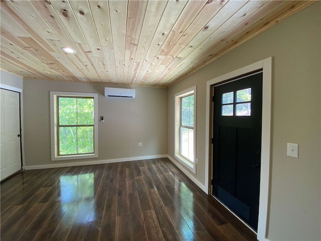 foyer entrance with a wall unit AC, healthy amount of natural light, dark wood-style floors, baseboards, and wooden ceiling