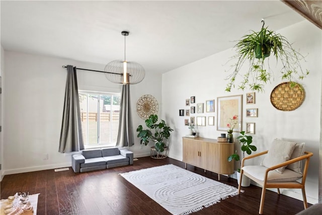 living area featuring wood finished floors and baseboards