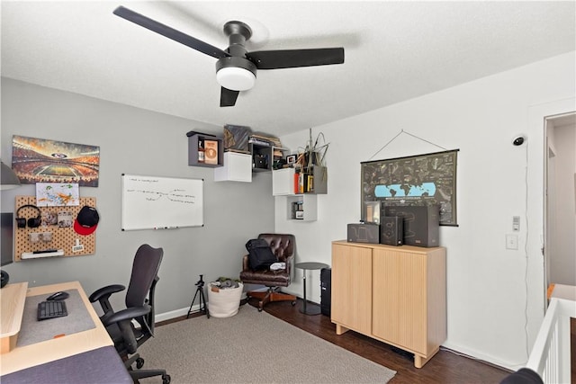 office space with ceiling fan, dark wood-style floors, and baseboards
