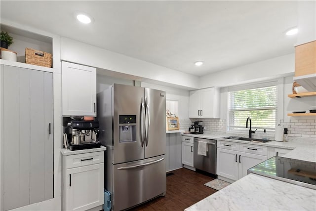 kitchen with stainless steel appliances, open shelves, a sink, dark wood-style flooring, and white cabinetry