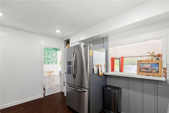 kitchen featuring stainless steel refrigerator with ice dispenser, dark wood-style floors, recessed lighting, and baseboards