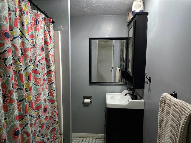 2711 Aspen Ln, Rogers, AR 72758 - bathroom featuring vanity, a shower with shower curtain, a textured ceiling, and tile patterned flooring