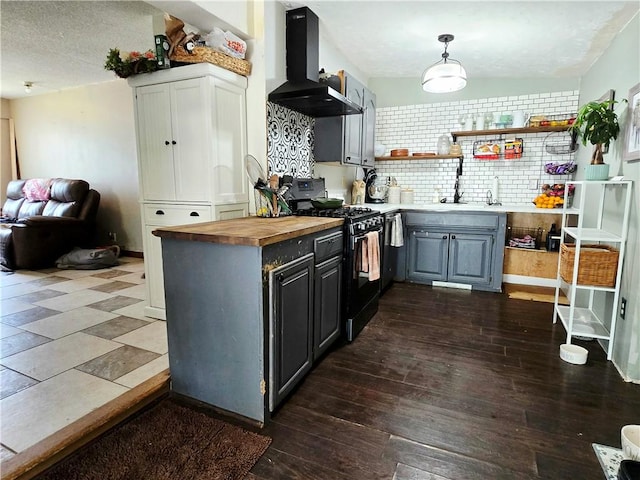 2711 Aspen Ln, Rogers, AR 72758 - kitchen with wall chimney exhaust hood, black gas range, butcher block countertops, gray cabinetry, and dark wood-style flooring