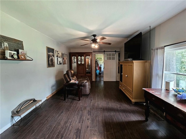 2711 Aspen Ln, Rogers, AR 72758 - living area featuring a barn door, dark wood-style flooring, and ceiling fan