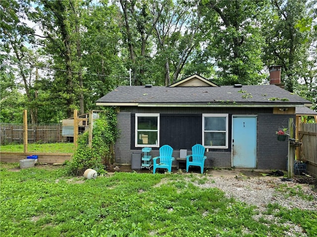 2711 Aspen Ln, Rogers, AR 72758 - rear view of property with brick siding, a chimney, and a shingled roof