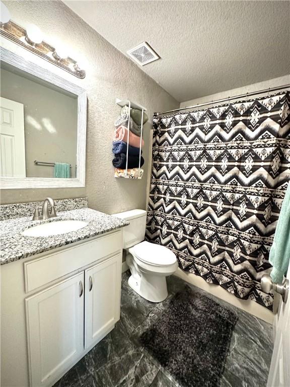 1213 Crutcher St, Springdale, AR 72764 - full bathroom featuring a textured wall, a shower with shower curtain, a textured ceiling, vanity, and toilet
