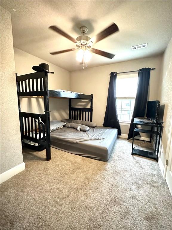 1213 Crutcher St, Springdale, AR 72764 - bedroom with carpet, a textured ceiling, baseboards, and a textured wall