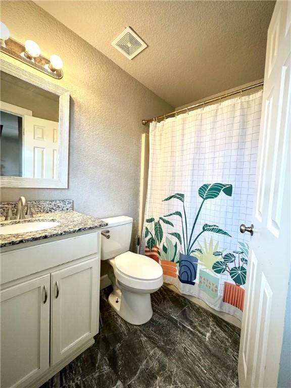 1213 Crutcher St, Springdale, AR 72764 - bathroom with a textured wall, vanity, toilet, a textured ceiling, and a shower with shower curtain