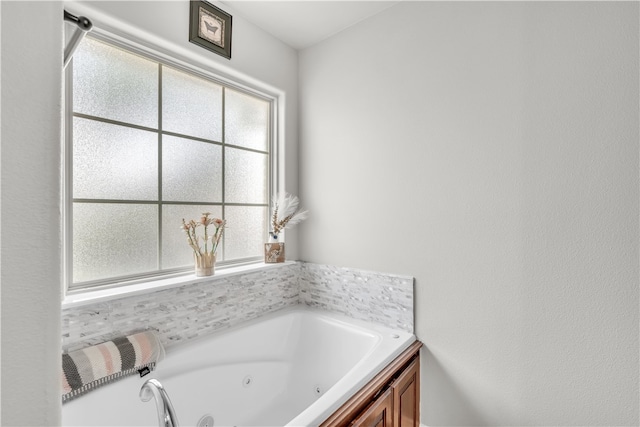 full bath with healthy amount of natural light and a jetted tub