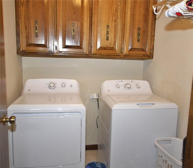 3001 Mcdonald Ave, Springdale, AR 72762 - clothes washing area with washing machine and clothes dryer, cabinet space, and tile patterned floors