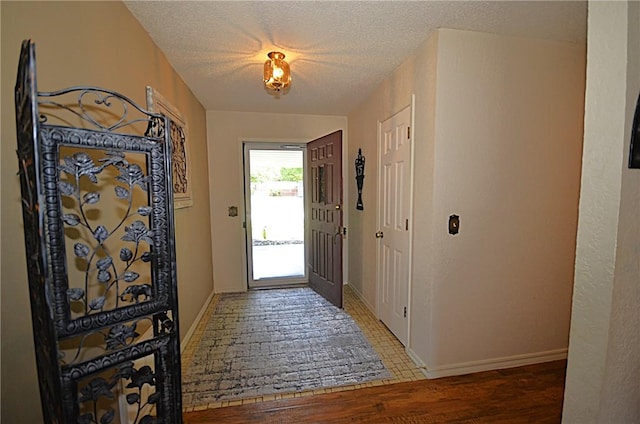 3001 Mcdonald Ave, Springdale, AR 72762 - entryway featuring wood finished floors, a textured ceiling, and baseboards