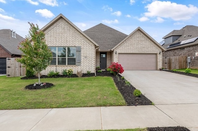 4400 SW Pawhuska St, Bentonville, AR 72713 - view of front of property featuring an attached garage, driveway, roof with shingles, and brick siding