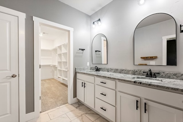 4400 SW Pawhuska St, Bentonville, AR 72713 - full bathroom with marble look tile flooring, double vanity, and a spacious closet