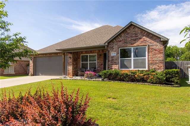 view of front facade with brick siding, an attached garage, concrete driveway, roof with shingles, and covered porch