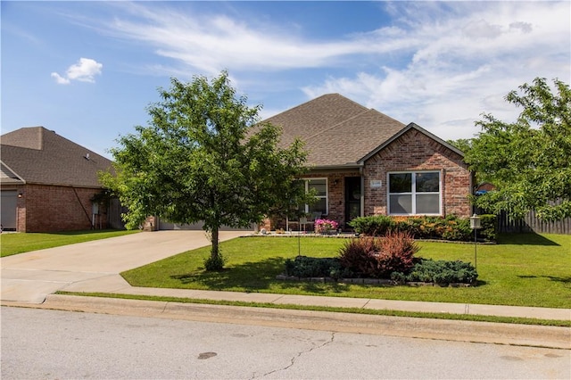view of front of home featuring concrete driveway, brick siding, a front lawn, and roof with shingles