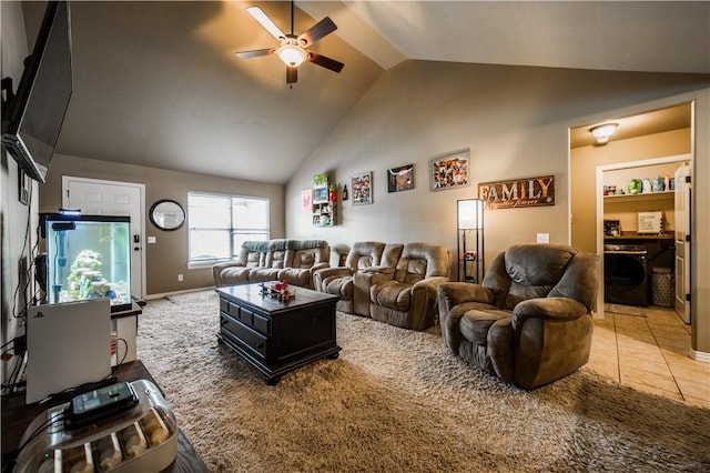 living area with a ceiling fan, high vaulted ceiling, and baseboards
