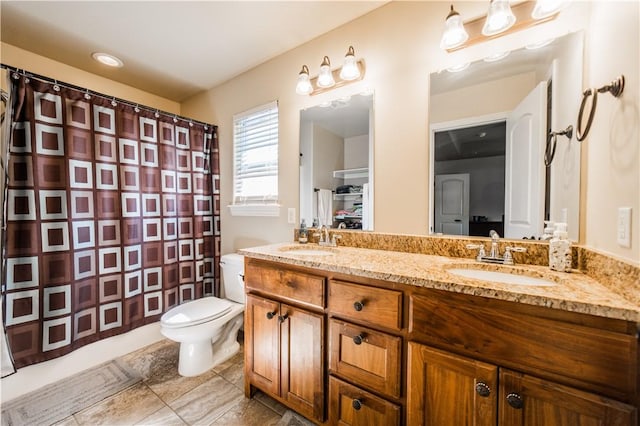 bathroom with a shower with curtain, double vanity, toilet, and tile patterned floors