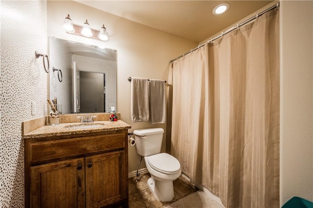bathroom with toilet, vanity, tile patterned flooring, and recessed lighting