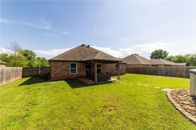 back of house featuring brick siding and a shingled roof