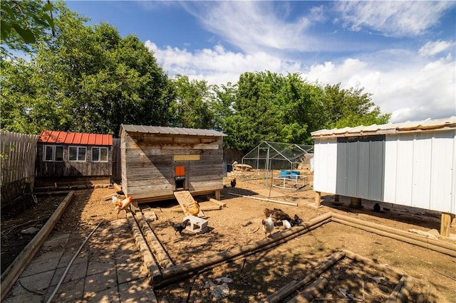 view of yard with exterior structure, an outdoor structure, and fence
