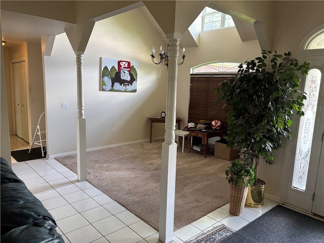 5095 Saxon St, Springdale, AR 72764 - entryway featuring ornate columns, light colored carpet, light tile patterned floors, and baseboards