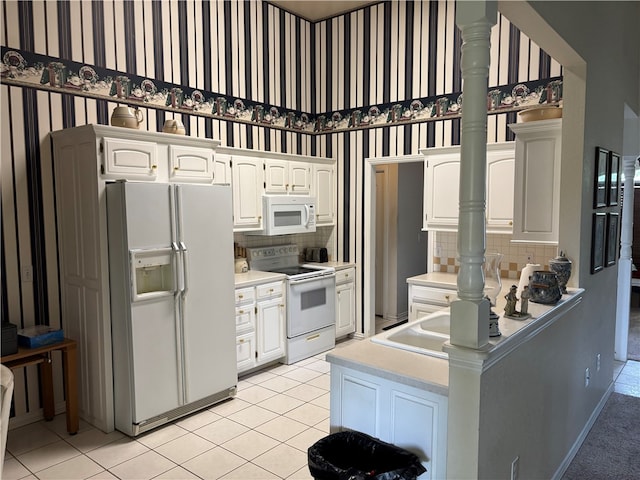 5095 Saxon St, Springdale, AR 72764 - kitchen featuring white appliances, white cabinetry, tasteful backsplash, and wallpapered walls