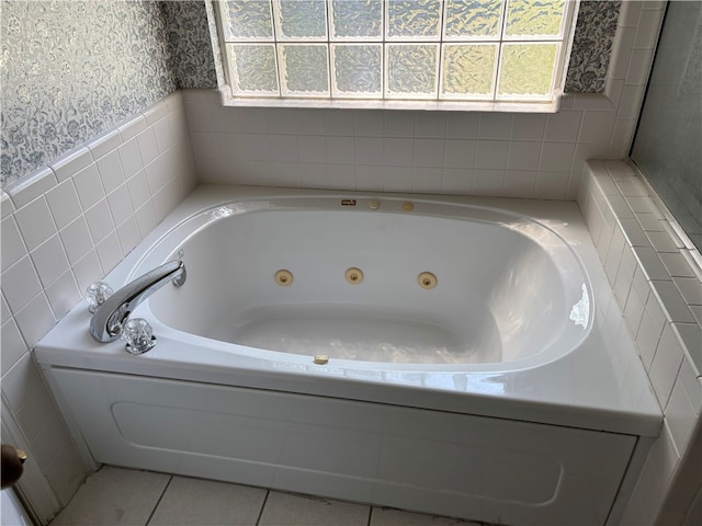 5095 Saxon St, Springdale, AR 72764 - bathroom with healthy amount of natural light, a whirlpool tub, wallpapered walls, tile walls, and tile patterned flooring