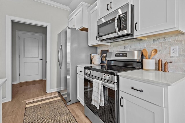 449 Hall St, West Fork, AR 72774 - kitchen featuring appliances with stainless steel finishes, ornamental molding, backsplash, white cabinets, and light wood-style flooring
