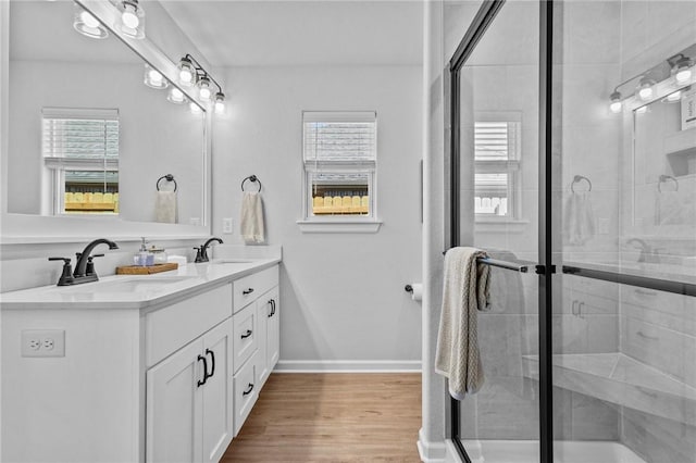 449 Hall St, West Fork, AR 72774 - bathroom featuring a shower stall, double vanity, wood finished floors, and baseboards