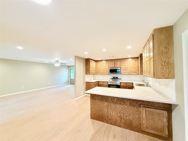 10098 Bayview Rd, Dardanelle, AR 72834 - kitchen featuring appliances with stainless steel finishes, a sink, light countertops, open floor plan, and recessed lighting