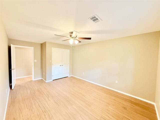 10098 Bayview Rd, Dardanelle, AR 72834 - unfurnished bedroom with baseboards, light wood finished floors, a ceiling fan, and a closet