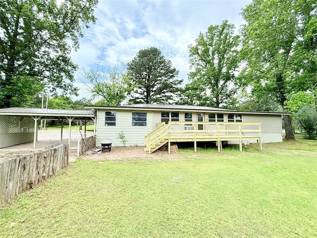 10098 Bayview Rd, Dardanelle, AR 72834 - rear view of house featuring a lawn, a detached carport, a wooden deck, and stairway