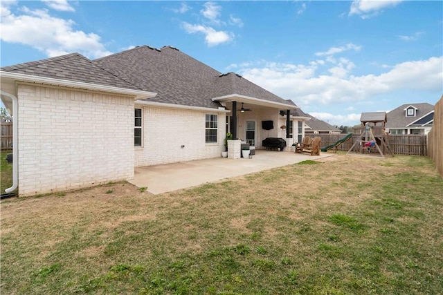 1904 Tull Dr, Pea Ridge, AR 72751 - rear view of property featuring a ceiling fan, roof with shingles, a patio area, a playground, and brick siding