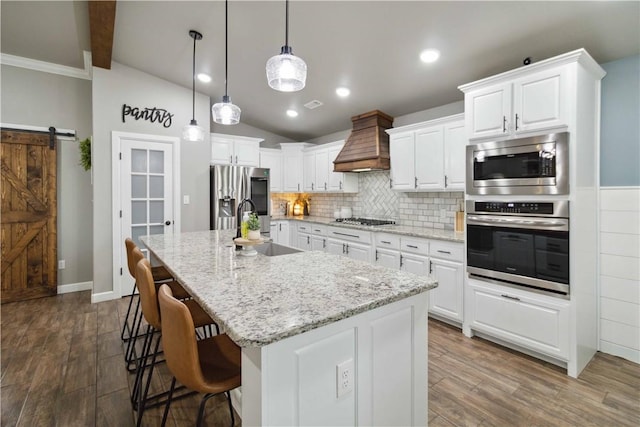1904 Tull Dr, Pea Ridge, AR 72751 - kitchen featuring appliances with stainless steel finishes, premium range hood, a sink, white cabinetry, and recessed lighting