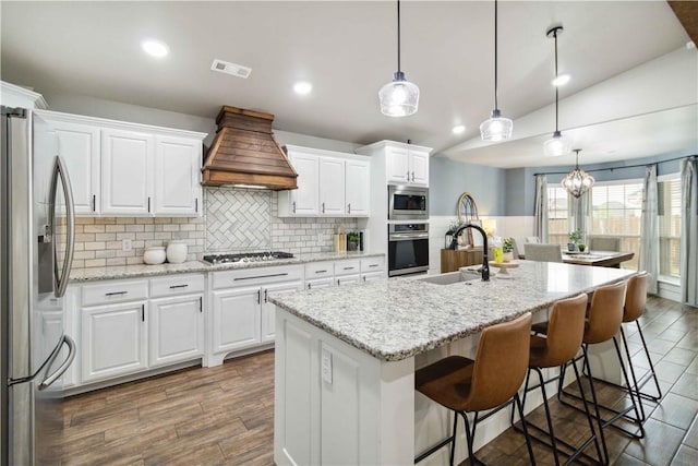 1904 Tull Dr, Pea Ridge, AR 72751 - kitchen with appliances with stainless steel finishes, a sink, custom range hood, backsplash, and white cabinets