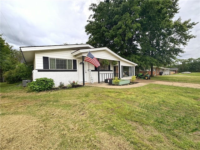 1008 E H St, Russellville, AR 72801 - view of front of house with a front yard, brick siding, and a porch