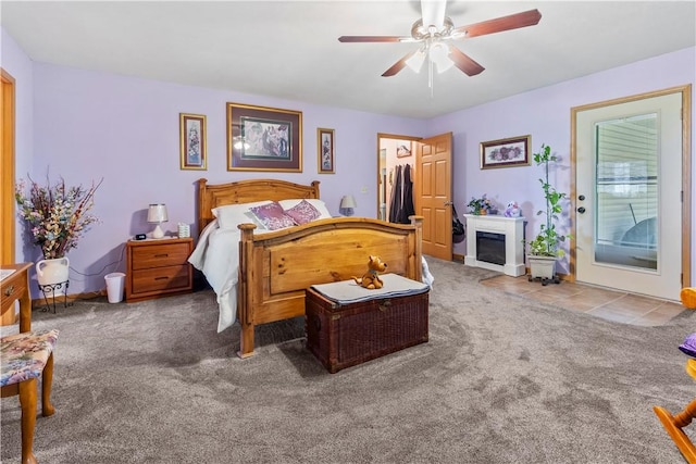 3277 Bellefonte Rd, Harrison, AR 72601 - carpeted bedroom featuring a glass covered fireplace, ceiling fan, and baseboards