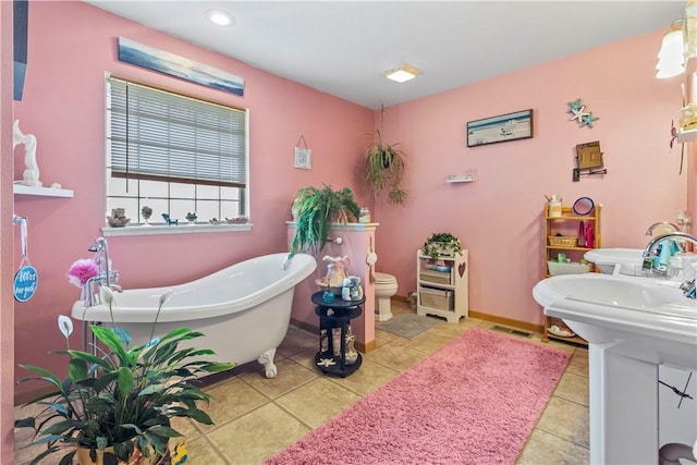 3277 Bellefonte Rd, Harrison, AR 72601 - bathroom with a soaking tub, toilet, tile patterned flooring, recessed lighting, and baseboards