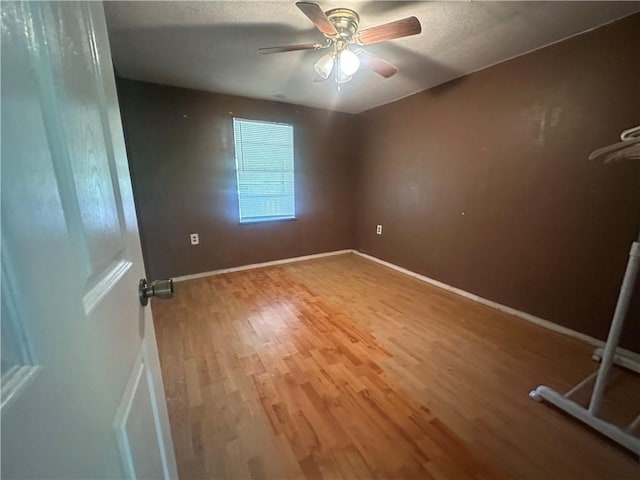 11836 Fresno Rd, West Fork, AR 72774 - empty room featuring wood finished floors, ceiling fan, and baseboards