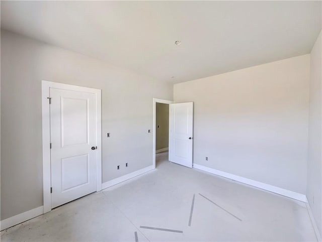 10 Olmsted Cir, Bella Vista, AR 72715 - unfurnished bedroom featuring baseboards and concrete flooring