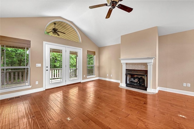 21 Sidlaw Hills Dr, Bella Vista, AR 72715 - unfurnished living room with ceiling fan, healthy amount of natural light, vaulted ceiling, wood finished floors, and baseboards