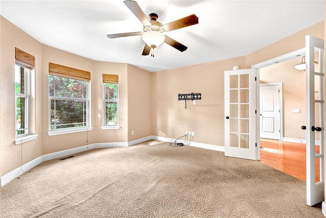 21 Sidlaw Hills Dr, Bella Vista, AR 72715 - carpeted spare room featuring french doors, baseboards, and a ceiling fan