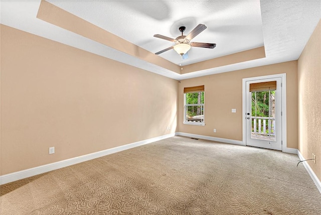 21 Sidlaw Hills Dr, Bella Vista, AR 72715 - carpeted empty room with a tray ceiling, a ceiling fan, and baseboards