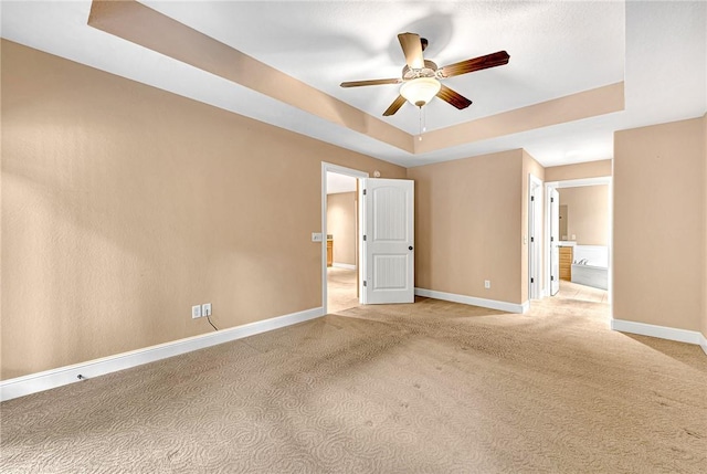 21 Sidlaw Hills Dr, Bella Vista, AR 72715 - unfurnished room with a tray ceiling, ceiling fan, baseboards, and light colored carpet